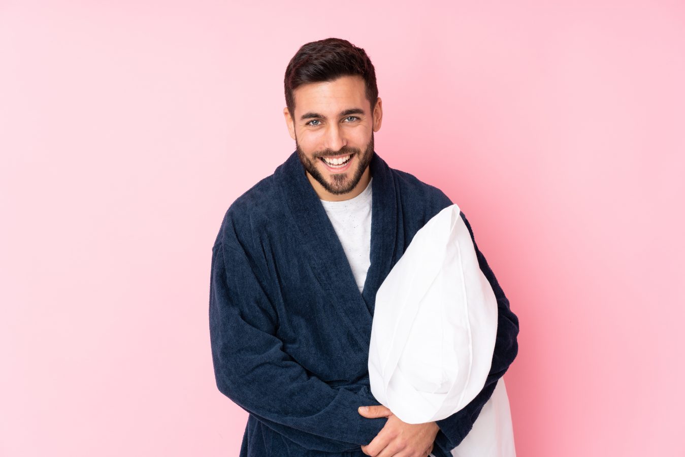 young-man-going-sleep-pink-wall-laughing